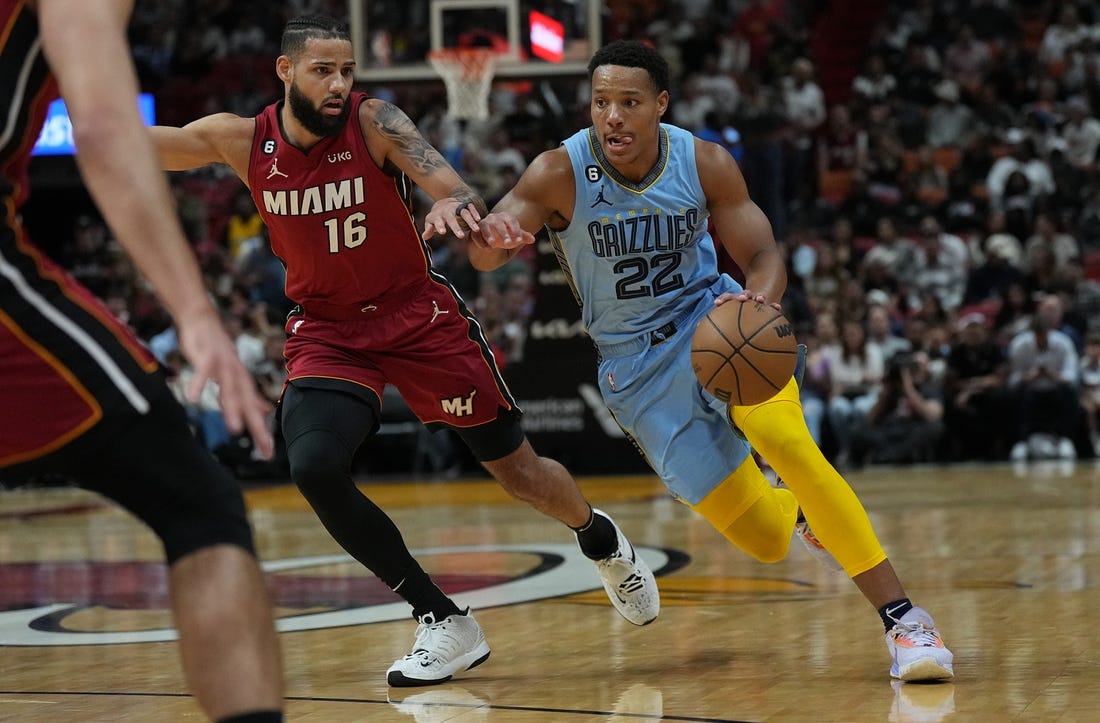 Mar 15, 2023; Miami, Florida, USA; Memphis Grizzlies guard Desmond Bane (22) drives to the basket as Miami Heat forward Caleb Martin (16) defends in the first half at Miami-Dade Arena. Mandatory Credit: Jim Rassol-USA TODAY Sports