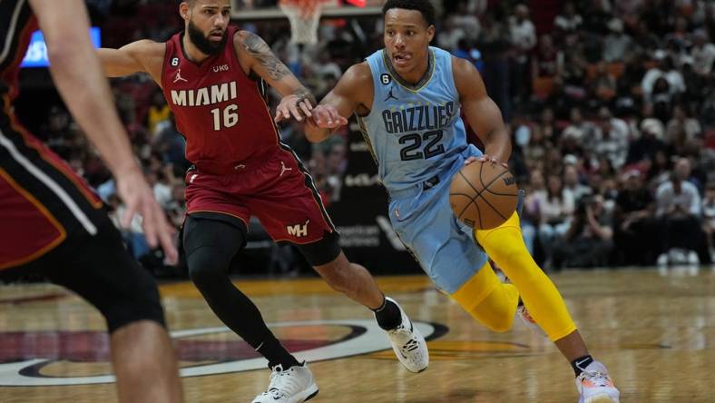 Mar 15, 2023; Miami, Florida, USA; Memphis Grizzlies guard Desmond Bane (22) drives to the basket as Miami Heat forward Caleb Martin (16) defends in the first half at Miami-Dade Arena. Mandatory Credit: Jim Rassol-USA TODAY Sports