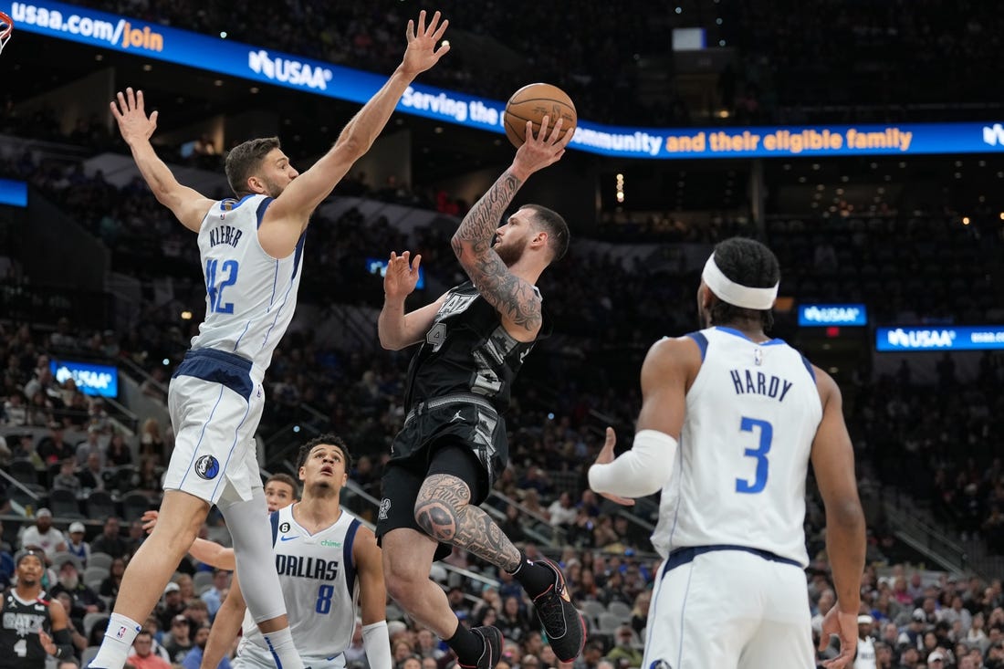 Mar 15, 2023; San Antonio, Texas, USA; San Antonio Spurs forward Sandro Mamukelashvili (54) shoots in front of Dallas Mavericks forward Maxi Kleber (42) in the first half at the AT&T Center. Mandatory Credit: Daniel Dunn-USA TODAY Sports