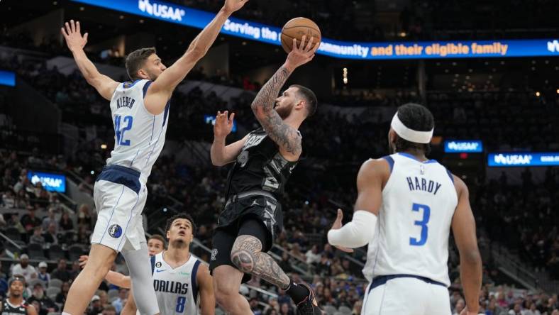 Mar 15, 2023; San Antonio, Texas, USA; San Antonio Spurs forward Sandro Mamukelashvili (54) shoots in front of Dallas Mavericks forward Maxi Kleber (42) in the first half at the AT&T Center. Mandatory Credit: Daniel Dunn-USA TODAY Sports