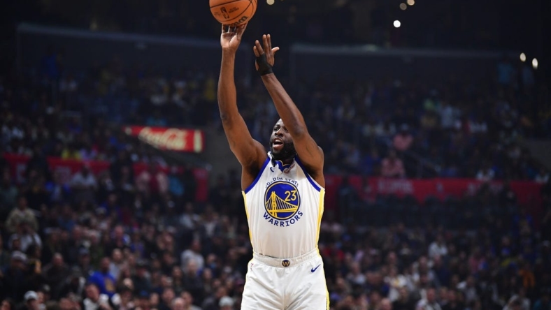 Mar 15, 2023; Los Angeles, California, USA; Golden State Warriors forward Draymond Green (23) shoots against the Los Angeles Clippers during the first half at Crypto.com Arena. Mandatory Credit: Gary A. Vasquez-USA TODAY Sports