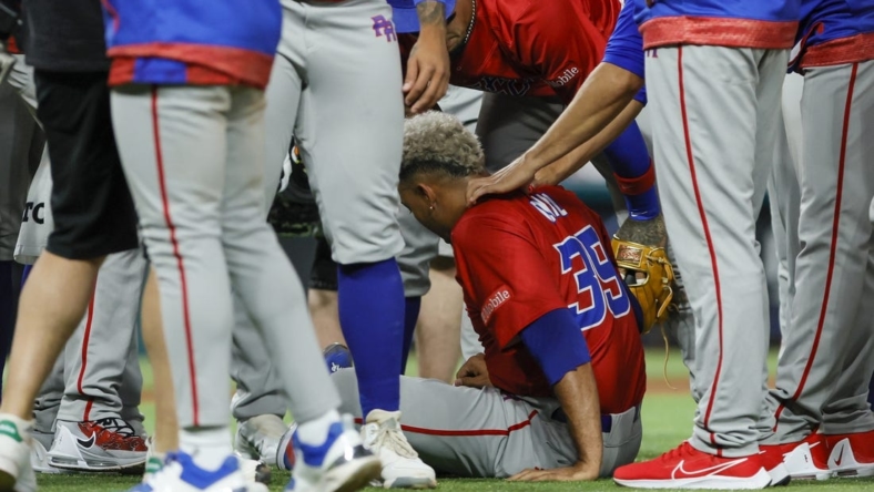 Mar 15, 2023; Miami, Florida, USA; Puerto Rico pitcher Edwin Diaz (39) sits on the field after an apparent leg injury during the team celebration against Dominican Republic at LoanDepot Park. Mandatory Credit: Sam Navarro-USA TODAY Sports