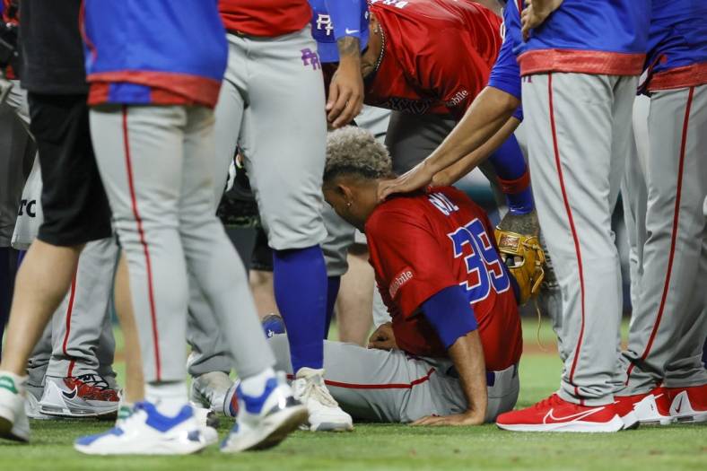 Mar 15, 2023; Miami, Florida, USA; Puerto Rico pitcher Edwin Diaz (39) sits on the field after an apparent leg injury during the team celebration against Dominican Republic at LoanDepot Park. Mandatory Credit: Sam Navarro-USA TODAY Sports