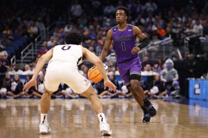 Mar 16, 2023; Orlando, FL, USA; Furman Paladins guard JP Pegues (1) dribbles the ball while defended by Virginia Cavaliers guard Kihei Clark (0) during the first half at Amway Center. Mandatory Credit: Matt Pendleton-USA TODAY Sports