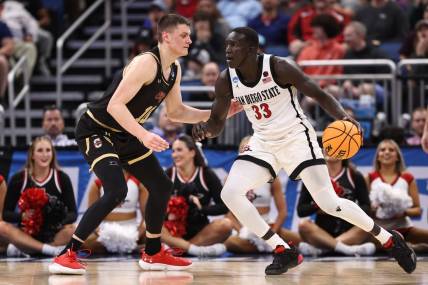 Mar 16, 2023; Orlando, FL, USA; San Diego State Aztecs forward Aguek Arop (33) dribbles the ball while defended by College of Charleston Cougars forward Ante Brzovic (10) during the second half at Amway Center. Mandatory Credit: Matt Pendleton-USA TODAY Sports