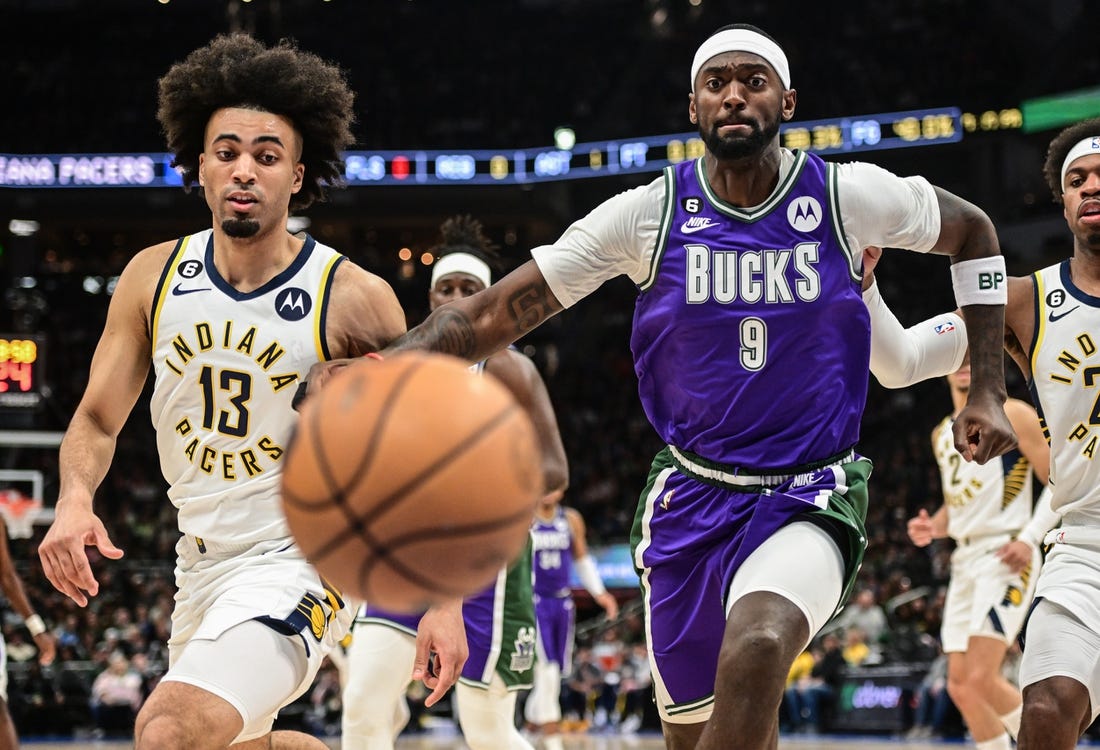 Mar 16, 2023; Milwaukee, Wisconsin, USA; Milwaukee Bucks forward Bobby Portis (9) and Indiana Pacers forward Jordan Nwora (13) chase a loose ball in the first quarter at Fiserv Forum. Mandatory Credit: Benny Sieu-USA TODAY Sports