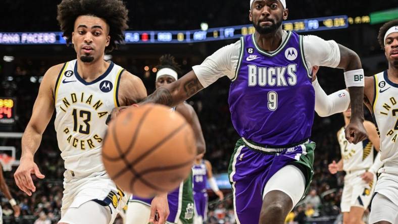 Mar 16, 2023; Milwaukee, Wisconsin, USA; Milwaukee Bucks forward Bobby Portis (9) and Indiana Pacers forward Jordan Nwora (13) chase a loose ball in the first quarter at Fiserv Forum. Mandatory Credit: Benny Sieu-USA TODAY Sports