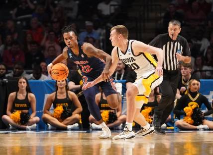 Mar 16, 2023; Birmingham, AL, USA; Auburn Tigers guard Allen Flanigan (22) is defended by Iowa Hawkeyes forward Payton Sandfort (20) during the second half in the first round of the 2023 NCAA Tournament at Legacy Arena. Mandatory Credit: Marvin Gentry-USA TODAY Sports