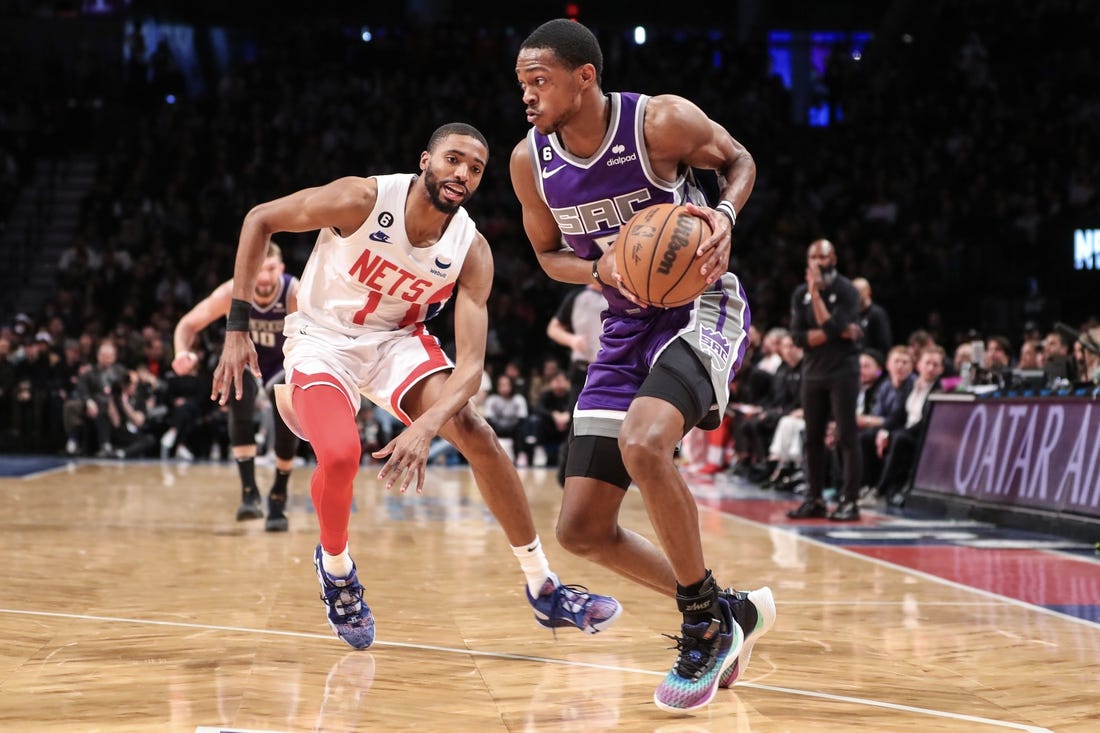 Mar 16, 2023; Brooklyn, New York, USA;  Sacramento Kings guard De'Aaron Fox (5) looks to drive past Brooklyn Nets forward Mikal Bridges (1) in the second quarter at Barclays Center. Mandatory Credit: Wendell Cruz-USA TODAY Sports