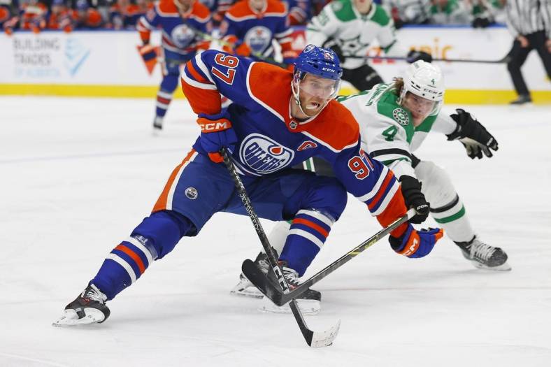Mar 16, 2023; Edmonton, Alberta, CAN;Edmonton Oilers forward Connor McDavid (97) carries the puck around Dallas Stars defensemen Miro Heiskanen (4) during the first period at Rogers Place. Mandatory Credit: Perry Nelson-USA TODAY Sports