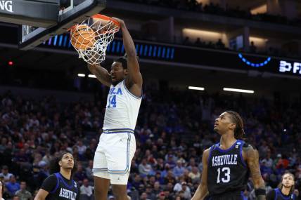 Mar 16, 2023; Sacramento, CA, USA; UCLA Bruins forward/center Kenneth Nwuba (14) dunks against the UNC Asheville Bulldogs in the first half at Golden 1 Center. Mandatory Credit: Kelley L Cox-USA TODAY Sports
