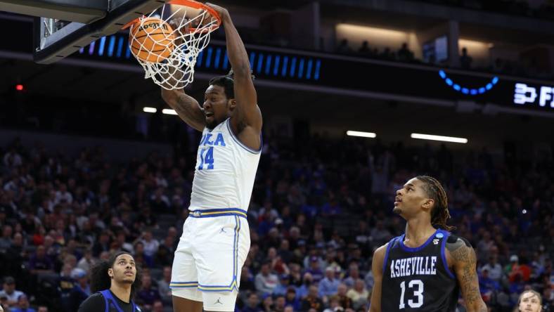 Mar 16, 2023; Sacramento, CA, USA; UCLA Bruins forward/center Kenneth Nwuba (14) dunks against the UNC Asheville Bulldogs in the first half at Golden 1 Center. Mandatory Credit: Kelley L Cox-USA TODAY Sports