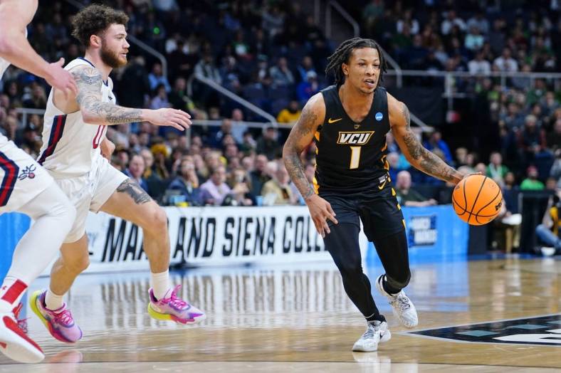 Mar 17, 2023; Albany, NY, USA; Virginia Commonwealth Rams guard Adrian Baldwin Jr. (1) dribbles the ball against the St. Mary's Gaels during the first half at MVP Arena. Mandatory Credit: Gregory Fisher-USA TODAY Sports