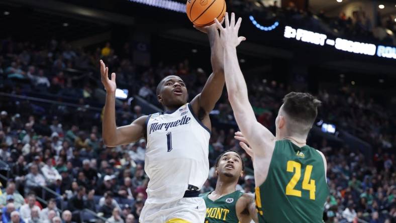 Mar 17, 2023; Columbus, OH, USA; Marquette Golden Eagles guard Kam Jones (1) shoots the ball over Vermont Catamounts forward Matt Veretto (24) in the second half at Nationwide Arena. Mandatory Credit: Rick Osentoski-USA TODAY Sports