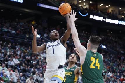 Mar 17, 2023; Columbus, OH, USA; Marquette Golden Eagles guard Kam Jones (1) shoots the ball over Vermont Catamounts forward Matt Veretto (24) in the second half at Nationwide Arena. Mandatory Credit: Rick Osentoski-USA TODAY Sports