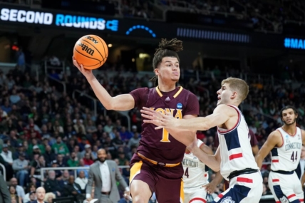 Mar 17, 2023; Albany, NY, USA; Iona Gaels guard Walter Clayton Jr. (1) passes the ball against UConn Huskies guard Joey Calcaterra (3) during the first half at MVP Arena. Mandatory Credit: David Butler II-USA TODAY Sports