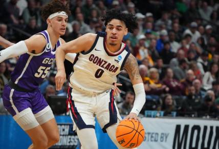 Mar 17, 2023; Denver, CO, USA; Gonzaga Bulldogs guard Julian Strawther (0) drives past Grand Canyon Antelopes guard Walter Ellis (55) during the first half at Ball Arena. Mandatory Credit: Ron Chenoy-USA TODAY Sports