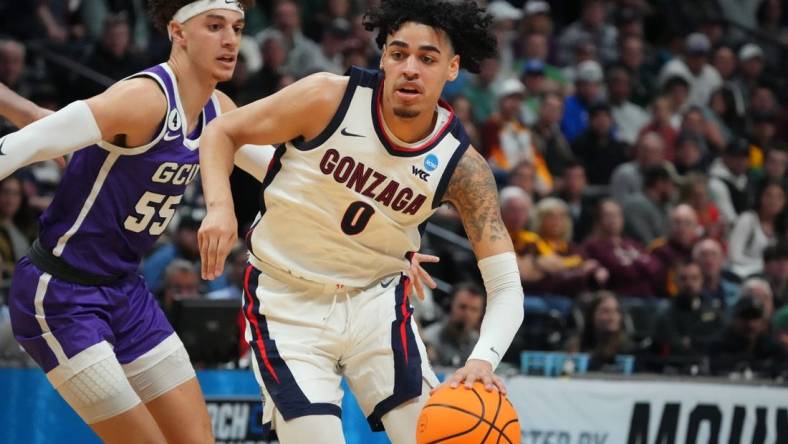 Mar 17, 2023; Denver, CO, USA; Gonzaga Bulldogs guard Julian Strawther (0) drives past Grand Canyon Antelopes guard Walter Ellis (55) during the first half at Ball Arena. Mandatory Credit: Ron Chenoy-USA TODAY Sports