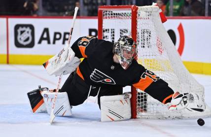 Mar 17, 2023; Philadelphia, Pennsylvania, USA; Philadelphia Flyers goalie Carter Hart (79) reaches for the puck against the Buffalo Sabres in the second period at Wells Fargo Center. Mandatory Credit: Kyle Ross-USA TODAY Sports
