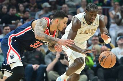 Mar 17, 2023; Cleveland, Ohio, USA; Washington Wizards forward Kyle Kuzma (33) and Cleveland Cavaliers guard Caris LeVert (3) go for a loose ball during the first half at Rocket Mortgage FieldHouse. Mandatory Credit: Ken Blaze-USA TODAY Sports
