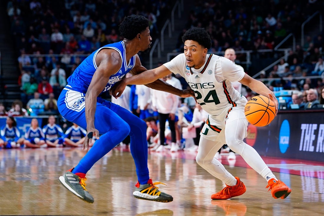 Mar 17, 2023; Albany, NY, USA; Miami Hurricanes guard Nijel Pack (24) controls the ball against Drake Bulldogs guard Sardaar Calhoun (14) in the second half at MVP Arena. Mandatory Credit: Gregory Fisher-USA TODAY Sports