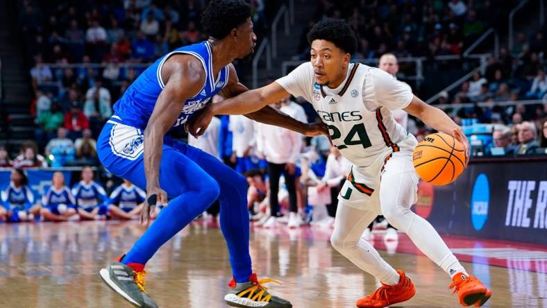 Mar 17, 2023; Albany, NY, USA; Miami Hurricanes guard Nijel Pack (24) controls the ball against Drake Bulldogs guard Sardaar Calhoun (14) in the second half at MVP Arena. Mandatory Credit: Gregory Fisher-USA TODAY Sports