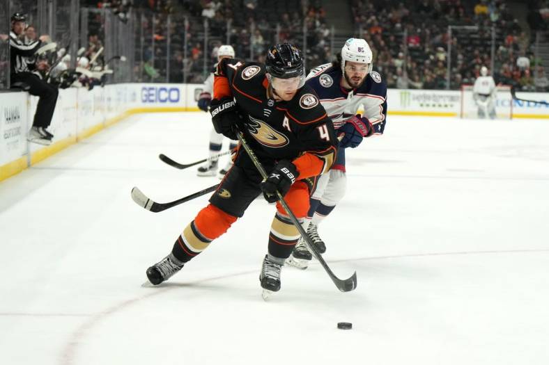 Mar 17, 2023; Anaheim, California, USA; Anaheim Ducks defenseman Cam Fowler (4) and Columbus Blue Jackets right wing Kirill Marchenko (86) battle for the puck in the first period at Honda Center. Mandatory Credit: Kirby Lee-USA TODAY Sports