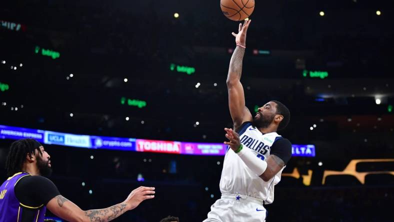 Mar 17, 2023; Los Angeles, California, USA; Dallas Mavericks guard Kyrie Irving (2) shoots against Los Angeles Lakers forward Anthony Davis (3) during the first half at Crypto.com Arena. Mandatory Credit: Gary A. Vasquez-USA TODAY Sports