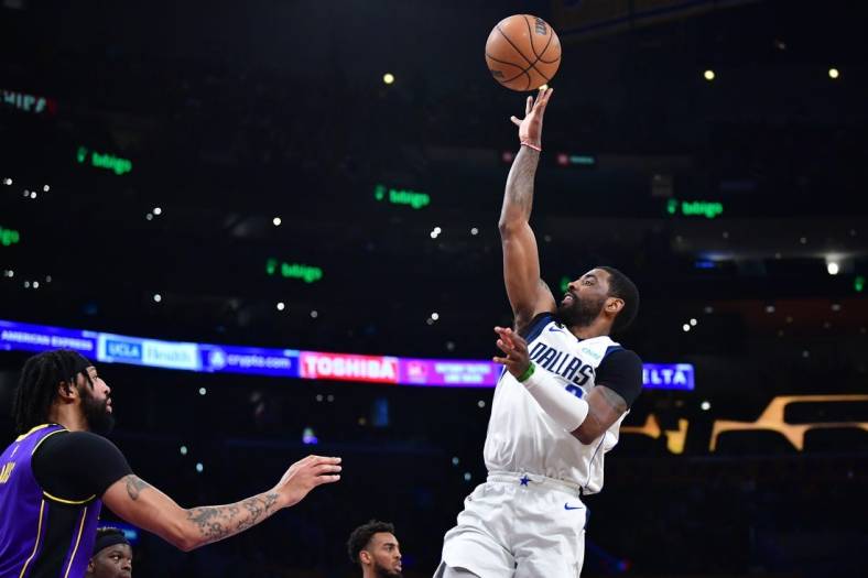 Mar 17, 2023; Los Angeles, California, USA; Dallas Mavericks guard Kyrie Irving (2) shoots against Los Angeles Lakers forward Anthony Davis (3) during the first half at Crypto.com Arena. Mandatory Credit: Gary A. Vasquez-USA TODAY Sports