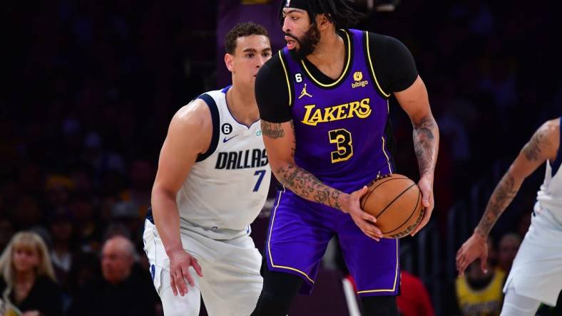 Mar 17, 2023; Los Angeles, California, USA; Los Angeles Lakers forward Anthony Davis (3) controls the ball against Dallas Mavericks center Dwight Powell (7) during the first half at Crypto.com Arena. Mandatory Credit: Gary A. Vasquez-USA TODAY Sports