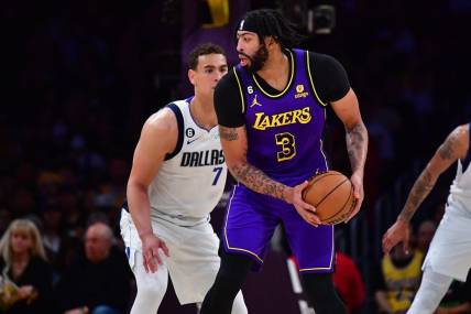 Mar 17, 2023; Los Angeles, California, USA; Los Angeles Lakers forward Anthony Davis (3) controls the ball against Dallas Mavericks center Dwight Powell (7) during the first half at Crypto.com Arena. Mandatory Credit: Gary A. Vasquez-USA TODAY Sports