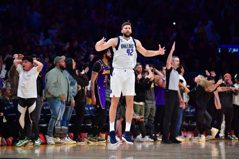 Mar 17, 2023; Los Angeles, California, USA; Dallas Mavericks forward Maxi Kleber (42) reacts after scoring a three point basket against Los Angeles Lakers forward Anthony Davis (3) for the game victory during the second half at Crypto.com Arena. Mandatory Credit: Gary A. Vasquez-USA TODAY Sports