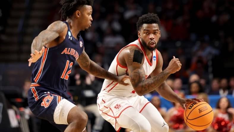 Mar 18, 2023; Birmingham, AL, USA; Houston Cougars guard Jamal Shead (1) dribbles against Auburn Tigers guard Zep Jasper (12) during the first half at Legacy Arena. Mandatory Credit: Vasha Hunt-USA TODAY Sports