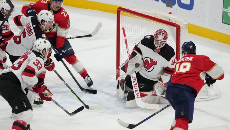 Mar 18, 2023; Sunrise, Florida, USA;  New Jersey Devils goaltender Akira Schmid (40) makes a save on a shot by Florida Panthers left wing Matthew Tkachuk (19) in the second period at FLA Live Arena. Mandatory Credit: Jim Rassol-USA TODAY Sports