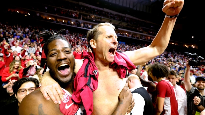 Mar 18, 2023; Des Moines, IA, USA; Arkansas Razorbacks head coach Eric Musselman (without shirt) celebrates with forward Makhel Mitchell (left) after defeating the Kansas Jayhawks  at Wells Fargo Arena. Mandatory Credit: Reese Strickland-USA TODAY Sports