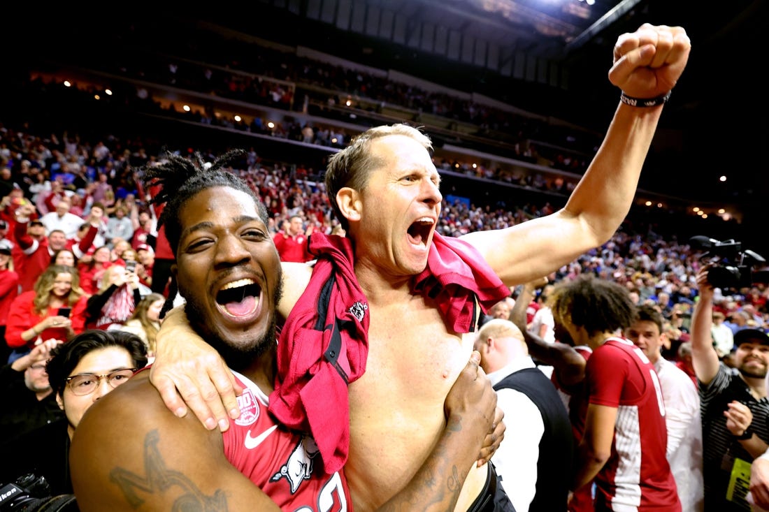Mar 18, 2023; Des Moines, IA, USA; Arkansas Razorbacks head coach Eric Musselman (without shirt) celebrates with forward Makhel Mitchell (left) after defeating the Kansas Jayhawks  at Wells Fargo Arena. Mandatory Credit: Reese Strickland-USA TODAY Sports