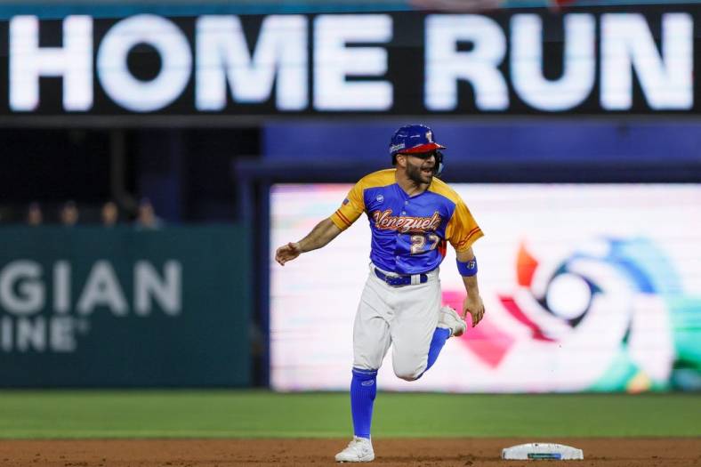 Mar 18, 2023; Miami, Florida, USA; Venezuela second baseman Jose Altuve (27) circles the bases after a two-run home run from first baseman Luis Arraez (not pictured) during the first inning against the USA at LoanDepot Park. Mandatory Credit: Sam Navarro-USA TODAY Sports