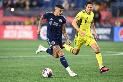 Mar 18, 2023; Foxborough, Massachusetts, USA; New England Revolution forward Gustavo Bou (7) controls the ball in front of Nashville SC midfielder Sean Davis (54) during the second half at Gillette Stadium. Mandatory Credit: Brian Fluharty-USA TODAY Sports