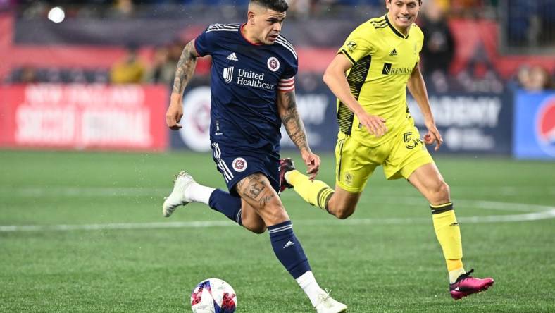 Mar 18, 2023; Foxborough, Massachusetts, USA; New England Revolution forward Gustavo Bou (7) controls the ball in front of Nashville SC midfielder Sean Davis (54) during the second half at Gillette Stadium. Mandatory Credit: Brian Fluharty-USA TODAY Sports