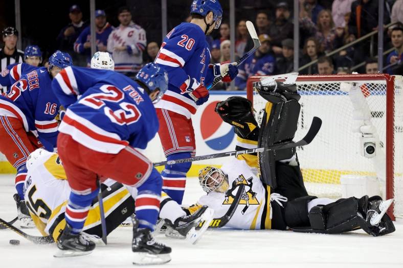 Mar 18, 2023; New York, New York, USA; Pittsburgh Penguins goaltender Tristan Jarry (35) guards the net against New York Rangers center Vincent Trocheck (16) and left wing Chris Kreider (20) and defenseman Adam Fox (23) during the first period at Madison Square Garden. Mandatory Credit: Brad Penner-USA TODAY Sports