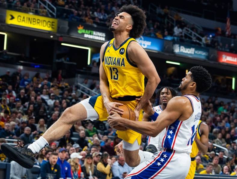 Mar 18, 2023; Indianapolis, Indiana, USA; Indiana Pacers forward Jordan Nwora (13) shoots the ball while Philadelphia 76ers forward Tobias Harris (12) defends in the first quarter at Gainbridge Fieldhouse. Mandatory Credit: Trevor Ruszkowski-USA TODAY Sports