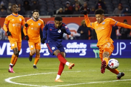Mar 18, 2023; Chicago, Illinois, USA; Chicago Fire midfielder Maren Haile-Selassie (7) shoots the ball against FC Cincinnati forward Brenner (9) during the first half at Soldier Field. Mandatory Credit: Mike Dinovo-USA TODAY Sports