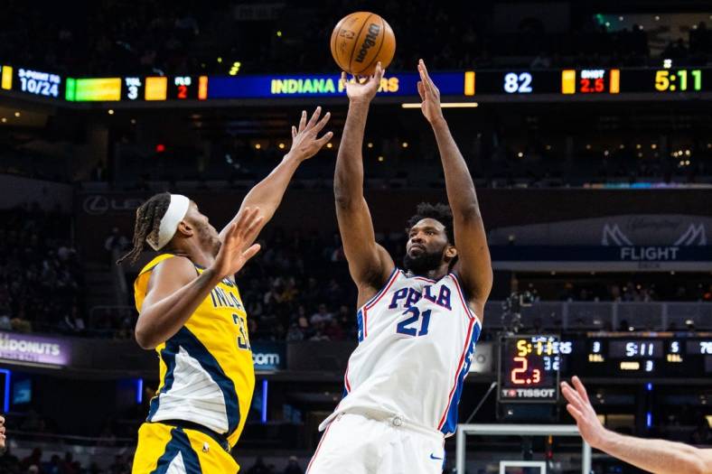 Mar 18, 2023; Indianapolis, Indiana, USA; Philadelphia 76ers center Joel Embiid (21) shoots the ball while Indiana Pacers center Myles Turner (33) defends in the second half at Gainbridge Fieldhouse. Mandatory Credit: Trevor Ruszkowski-USA TODAY Sports