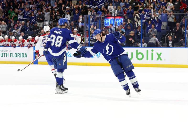 Mar 18, 2023; Tampa, Florida, USA;Tampa Bay Lightning left wing Brandon Hagel (38) is congratulated by center Brayden Point (21) after he scored a goal for a hat trick against the Montreal Canadiens during the third period at Amalie Arena. Mandatory Credit: Kim Klement-USA TODAY Sports