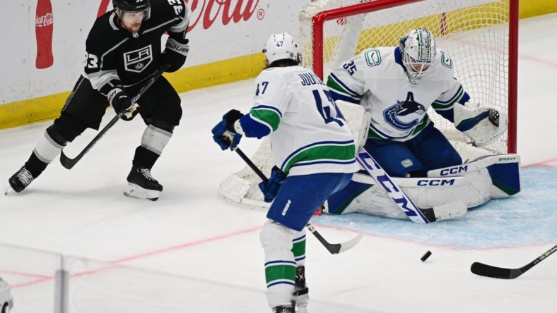 Mar 18, 2023; Los Angeles, California, USA;  Vancouver Canucks goaltender Thatcher Demko (35) makes a save as Los Angeles Kings right wing Viktor Arvidsson (33) looks for the puck in a NHL game at Crypto.com Arena. Mandatory Credit: Richard Mackson-USA TODAY Sports