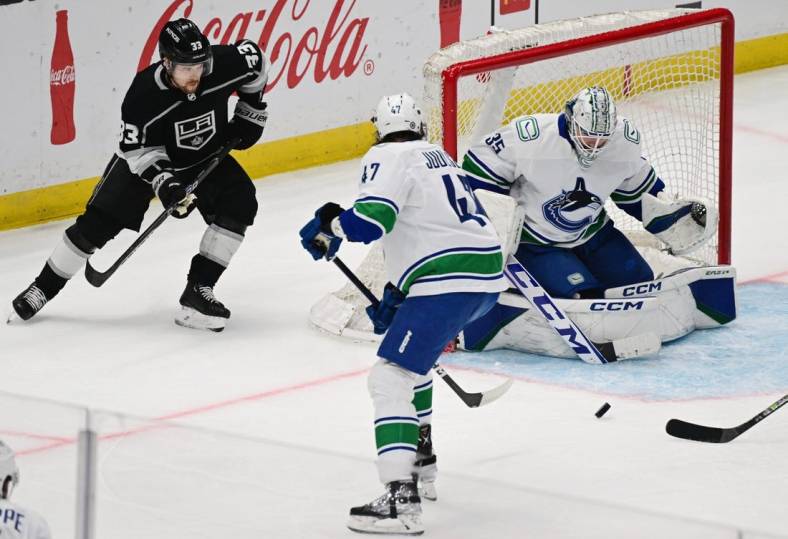 Mar 18, 2023; Los Angeles, California, USA;  Vancouver Canucks goaltender Thatcher Demko (35) makes a save as Los Angeles Kings right wing Viktor Arvidsson (33) looks for the puck in a NHL game at Crypto.com Arena. Mandatory Credit: Richard Mackson-USA TODAY Sports