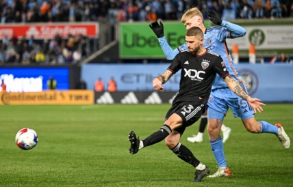 Mar 18, 2023; New York, New York, USA; D.C. United midfielder Mateusz Klich (43) crosses the ball defended by New York City FC midfielder Keaton Parks (55) during the second half at Yankee Stadium. Mandatory Credit: Mark Smith-USA TODAY Sports