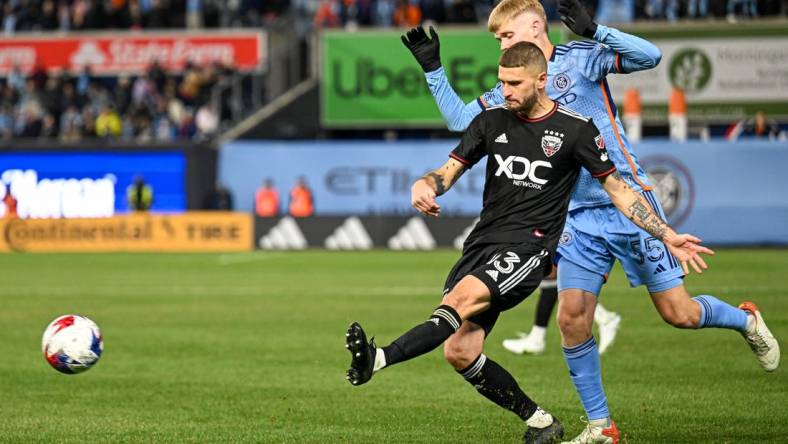 Mar 18, 2023; New York, New York, USA; D.C. United midfielder Mateusz Klich (43) crosses the ball defended by New York City FC midfielder Keaton Parks (55) during the second half at Yankee Stadium. Mandatory Credit: Mark Smith-USA TODAY Sports