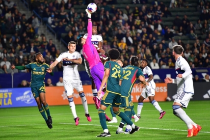 Mar 18, 2023; Carson, California, USA; Los Angeles Galaxy goalkeeper Jonathan Bond (1) blocks a shot against the Vancouver Whitecaps during the first half at Dignity Health Sports Park. Mandatory Credit: Gary A. Vasquez-USA TODAY Sports