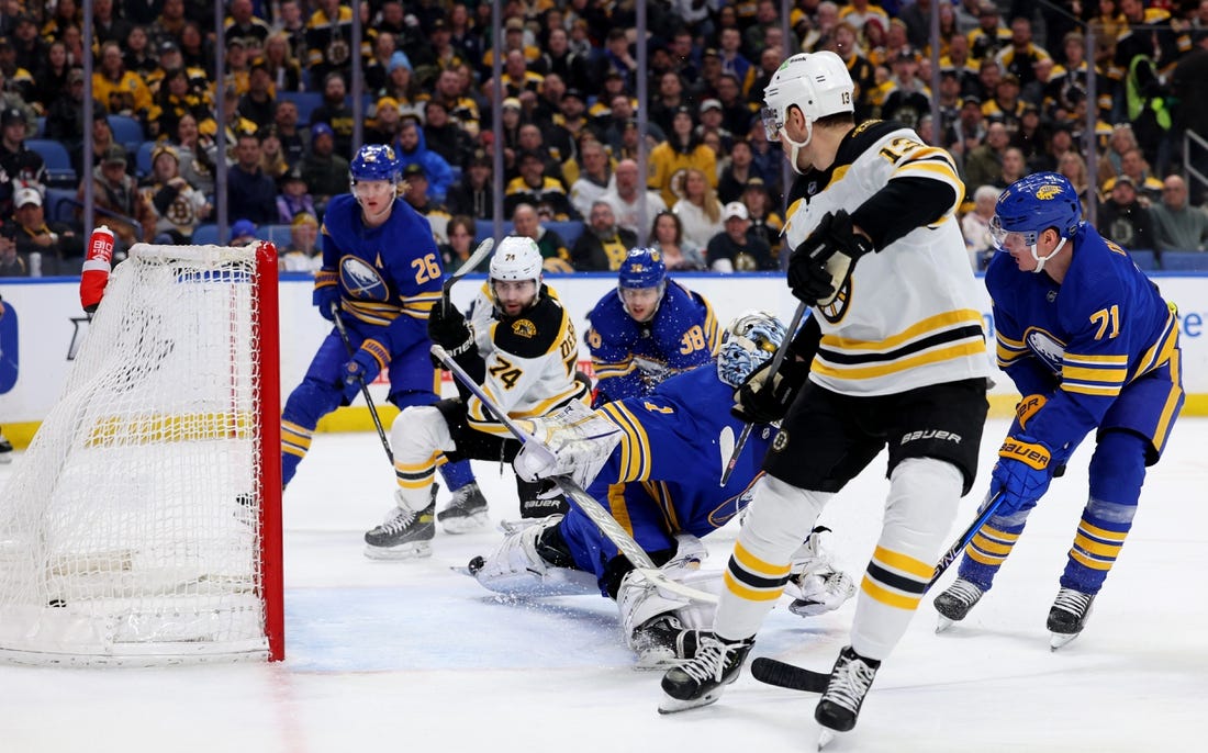 Mar 19, 2023; Buffalo, New York, USA;  Boston Bruins left wing Jake DeBrusk (74) scores a goal on Buffalo Sabres goaltender Ukko-Pekka Luukkonen (1) during the first period at KeyBank Center. Mandatory Credit: Timothy T. Ludwig-USA TODAY Sports